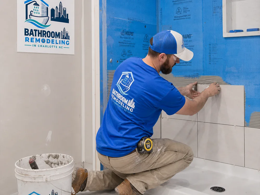Installer preparing and waterproofing a tiled shower surround